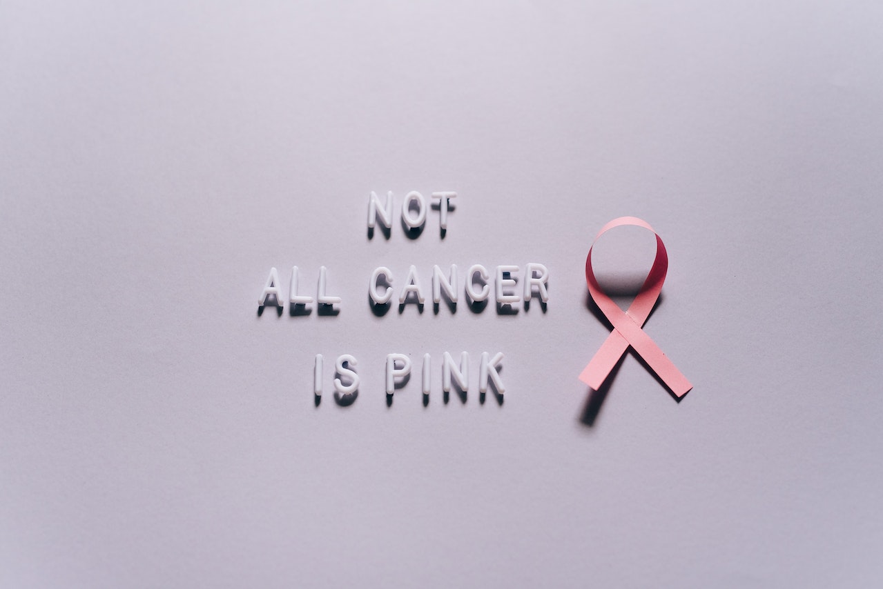 A pink ribbon and words

Description automatically generated