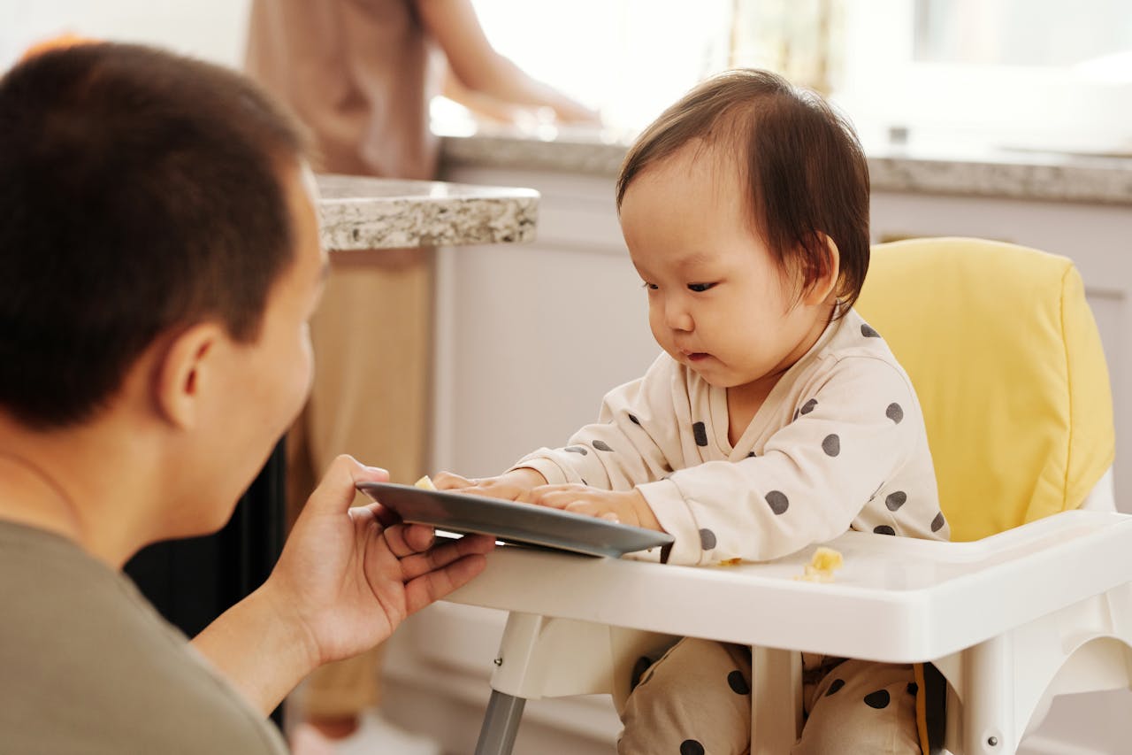 A person giving baby food